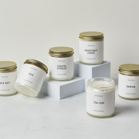 Makana Apothecary Jar Candles with gold lids in assorted fragrances on white background
